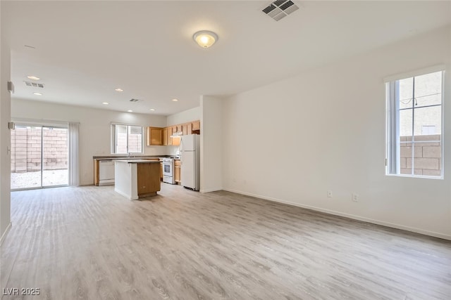 4045 Oliver Sagebrush Dr, Las Vegas, NV 89122 - unfurnished living room with baseboards, light wood-type flooring, and visible vents