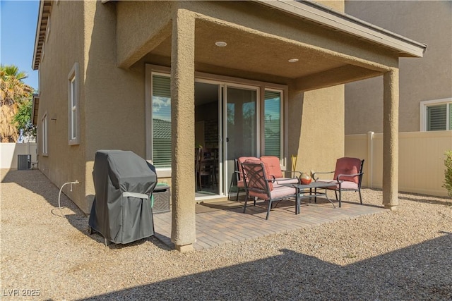 view of patio featuring fence, area for grilling, and central AC