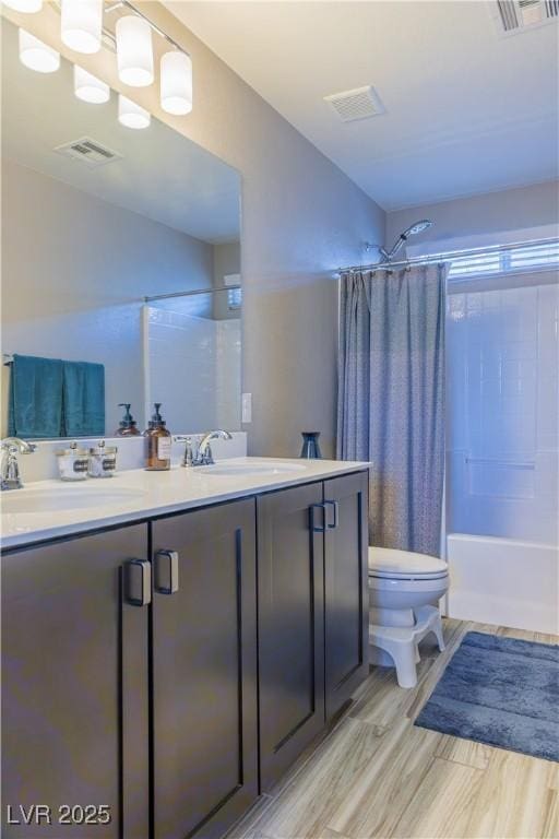 full bathroom featuring a sink, shower / bathtub combination with curtain, toilet, and visible vents