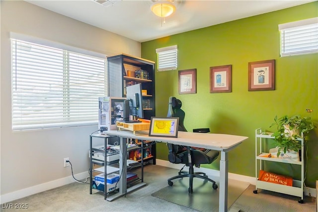 office space featuring baseboards, plenty of natural light, and carpet