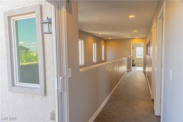 hallway with baseboards, recessed lighting, and carpet