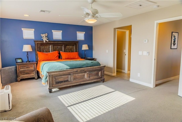 carpeted bedroom featuring visible vents, baseboards, and ceiling fan