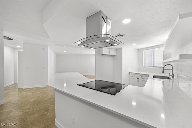 kitchen featuring recessed lighting, a sink, black electric cooktop, and island range hood