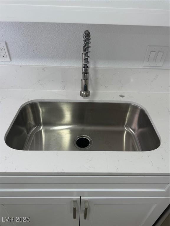 details with light stone counters and a sink