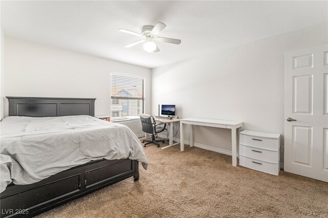 carpeted bedroom with ceiling fan and baseboards