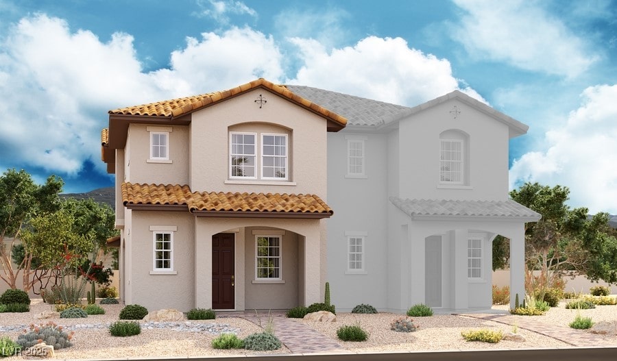 mediterranean / spanish house with stucco siding and a tile roof