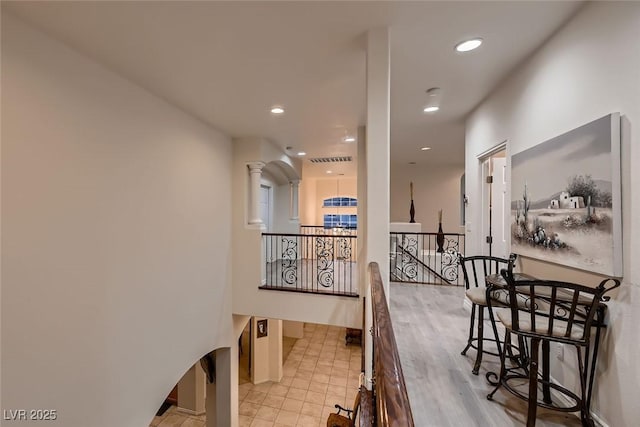 6750 Quapaw St, Las Vegas, NV 89149 - corridor featuring decorative columns, visible vents, baseboards, an upstairs landing, and recessed lighting