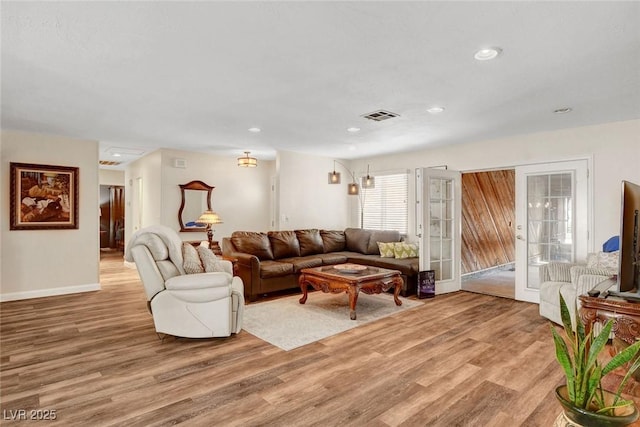 living room featuring baseboards, recessed lighting, light wood-style flooring, and visible vents