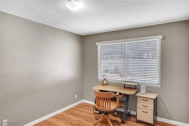 home office featuring baseboards and light wood-type flooring