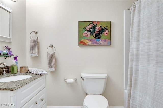 full bathroom with vanity, baseboards, and toilet