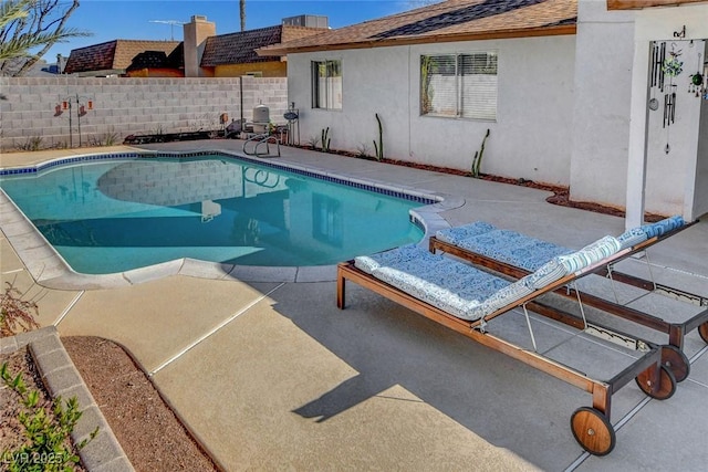 view of swimming pool with a fenced in pool, a patio area, and fence