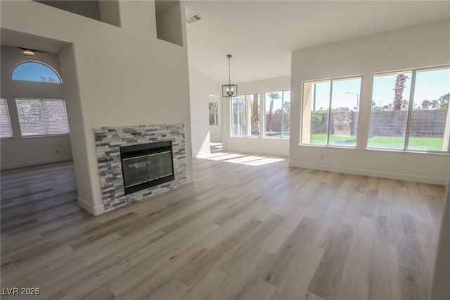 4416 Inez Dr, Las Vegas, NV 89130 - unfurnished living room with baseboards, a stone fireplace, wood finished floors, and visible vents