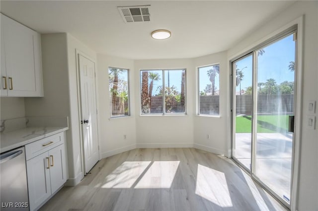 4416 Inez Dr, Las Vegas, NV 89130 - unfurnished dining area with baseboards, plenty of natural light, light wood-style flooring, and visible vents