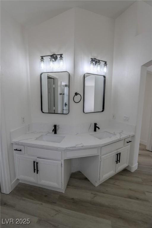 4416 Inez Dr, Las Vegas, NV 89130 - bathroom featuring double vanity, a sink, and wood finished floors