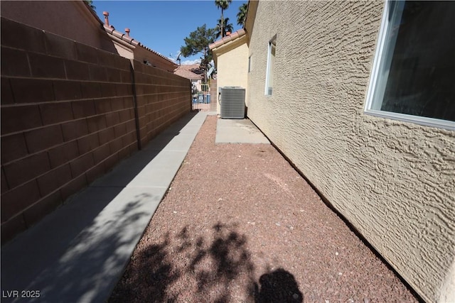 4416 Inez Dr, Las Vegas, NV 89130 - view of side of property with fence, central AC unit, and stucco siding