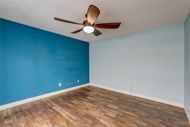 empty room with baseboards, a ceiling fan, and wood finished floors