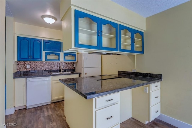 kitchen with white appliances, glass insert cabinets, dark wood-style floors, blue cabinets, and a sink