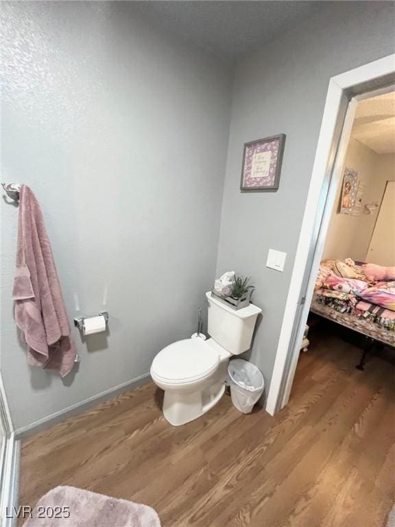 bathroom with wood finished floors and toilet