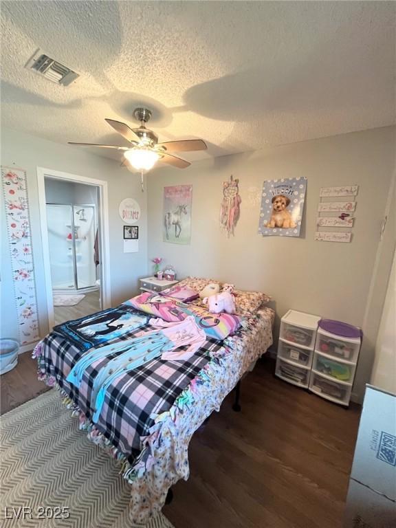 bedroom with visible vents, a ceiling fan, a textured ceiling, and wood finished floors