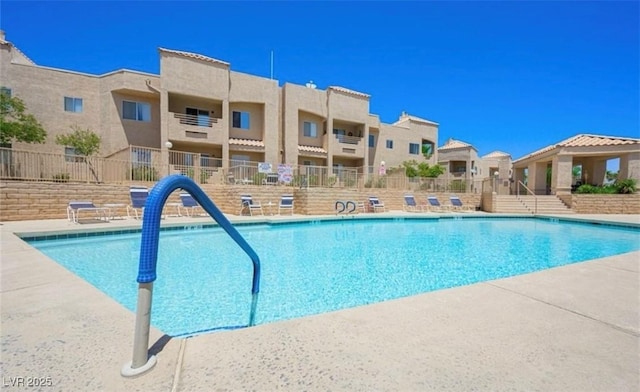 pool with fence and a residential view
