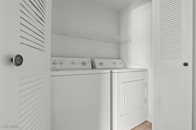 washroom featuring laundry area and washer and clothes dryer