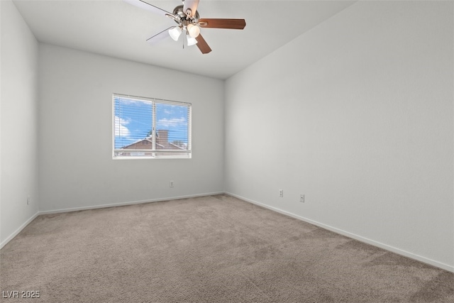 spare room with light colored carpet, baseboards, and ceiling fan