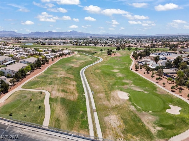 aerial view featuring a mountain view, golf course view, and a residential view