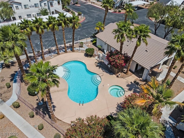 pool with fence and a patio area