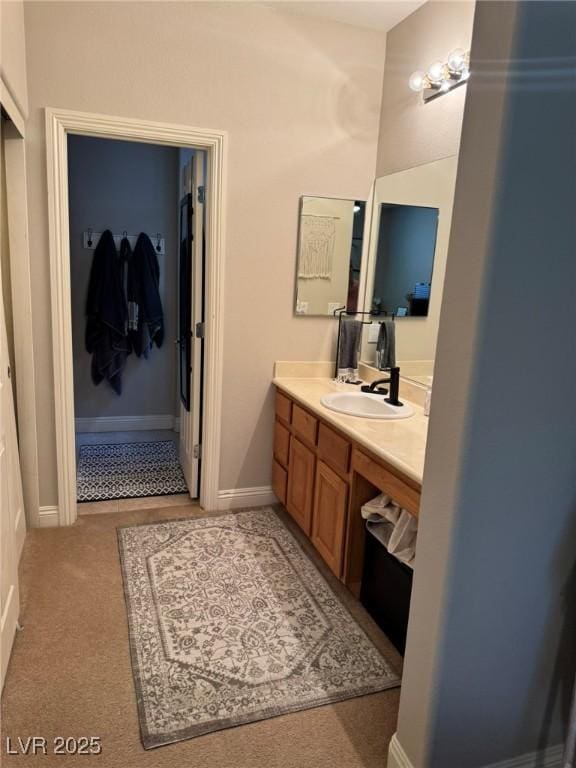 bathroom with baseboards and vanity