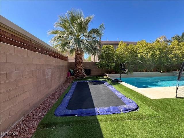 view of swimming pool with a fenced in pool, a fenced backyard, and a yard