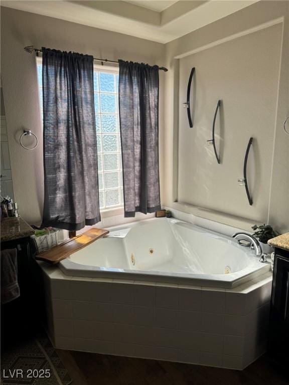 bathroom featuring vanity and a whirlpool tub