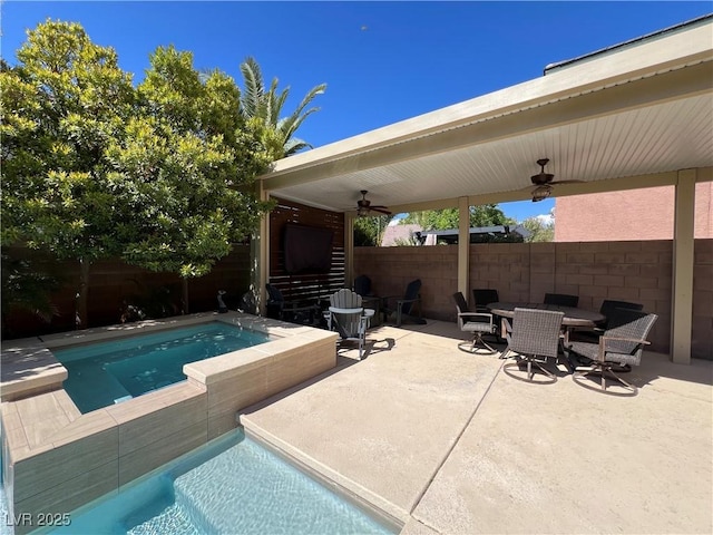 view of swimming pool with ceiling fan, fence private yard, a patio area, a fenced in pool, and outdoor dining space
