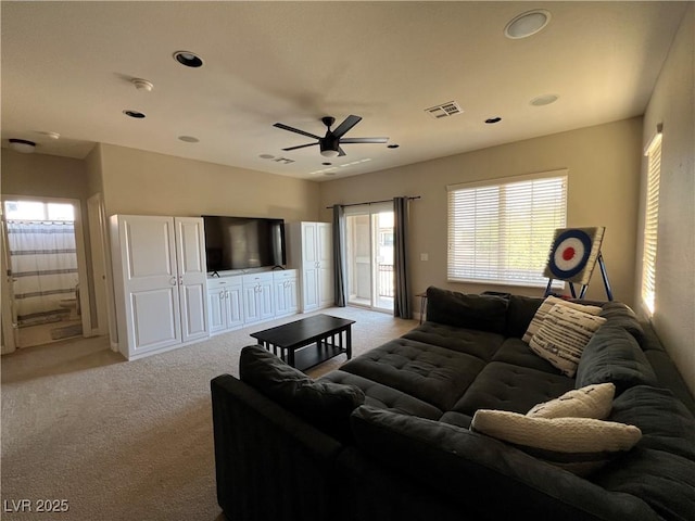 carpeted living area with visible vents, a ceiling fan, and recessed lighting