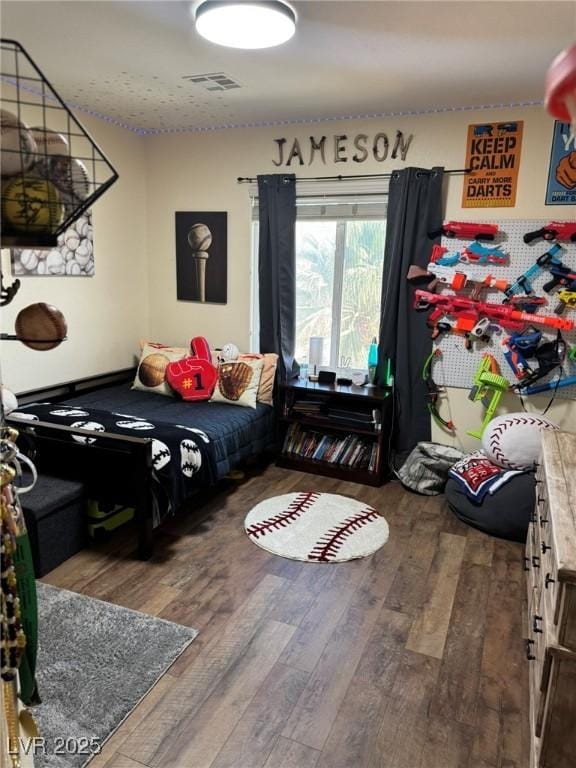 bedroom featuring wood-type flooring and visible vents