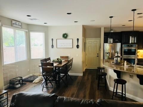 7109 Rancho De Taos, Las Vegas, NV 89130 - dining space featuring baseboards, dark wood-style floors, and radiator
