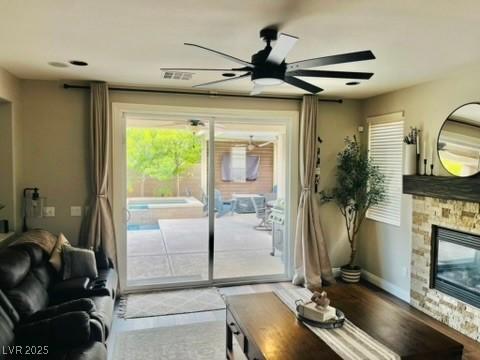 7109 Rancho De Taos, Las Vegas, NV 89130 - living room featuring ceiling fan, a fireplace, baseboards, and wood finished floors