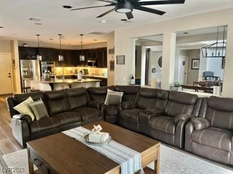 7109 Rancho De Taos, Las Vegas, NV 89130 - living area featuring a ceiling fan, wood finished floors, and a chandelier