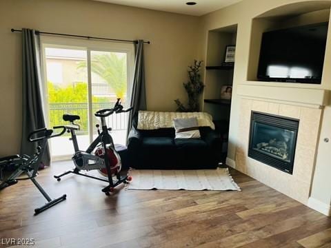 7109 Rancho De Taos, Las Vegas, NV 89130 - workout room featuring wood finished floors, a glass covered fireplace, and built in shelves