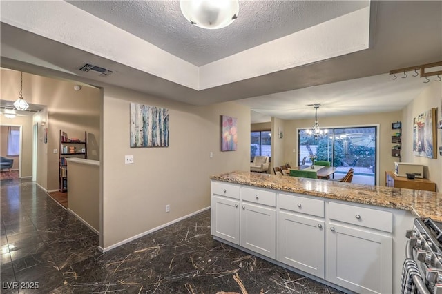 kitchen featuring white cabinets, baseboards, high end range, and marble finish floor