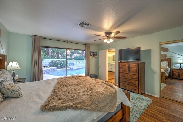 bedroom featuring a ceiling fan, access to exterior, visible vents, arched walkways, and wood finished floors