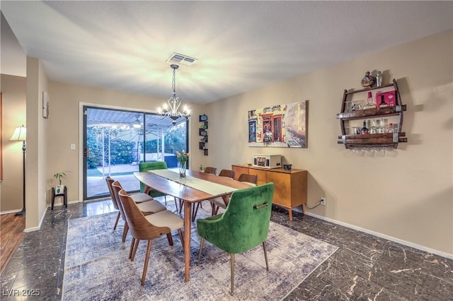 dining space featuring a chandelier, baseboards, and visible vents