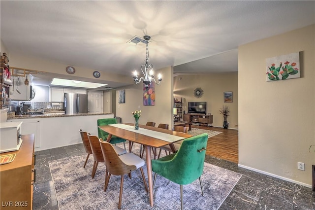 dining area with a chandelier, baseboards, and visible vents