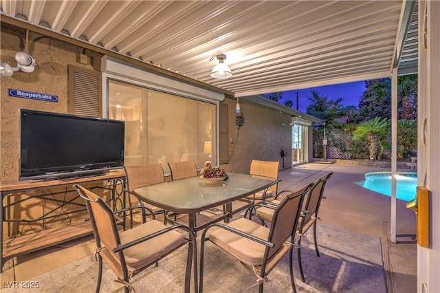 view of patio / terrace with outdoor dining area and an outdoor pool