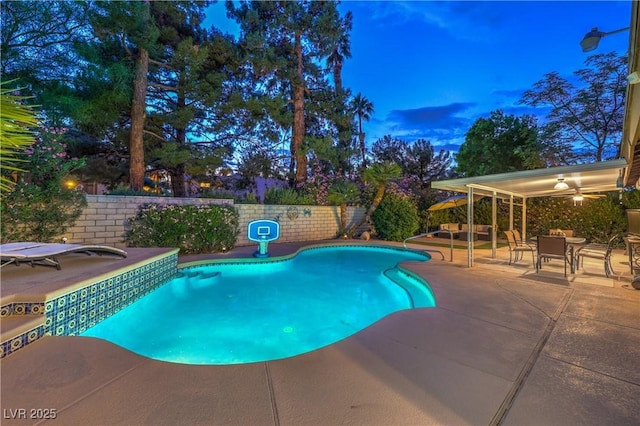 view of swimming pool featuring a patio, outdoor dining area, and a fenced in pool