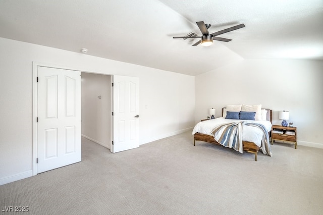 bedroom featuring baseboards, ceiling fan, vaulted ceiling, and light colored carpet