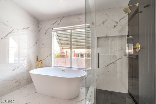 full bath with a soaking tub, stone wall, a marble finish shower, and marble finish floor