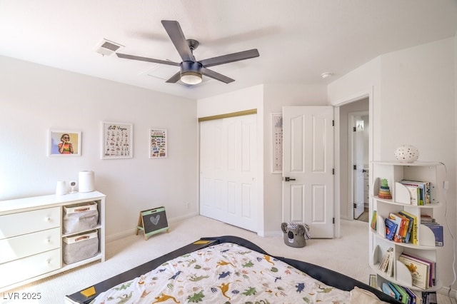 carpeted bedroom featuring baseboards, ceiling fan, a closet, and visible vents