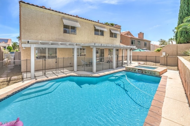view of swimming pool with a patio area, fence, a pergola, and a pool with connected hot tub