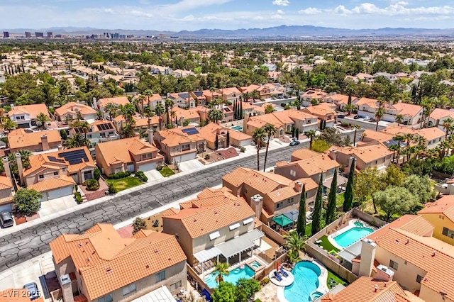 drone / aerial view featuring a residential view and a mountain view