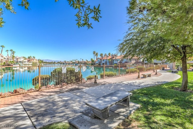view of property's community featuring a water view, fence, and a residential view